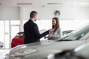 Dealer speaking with a client in a dealership.jpeg